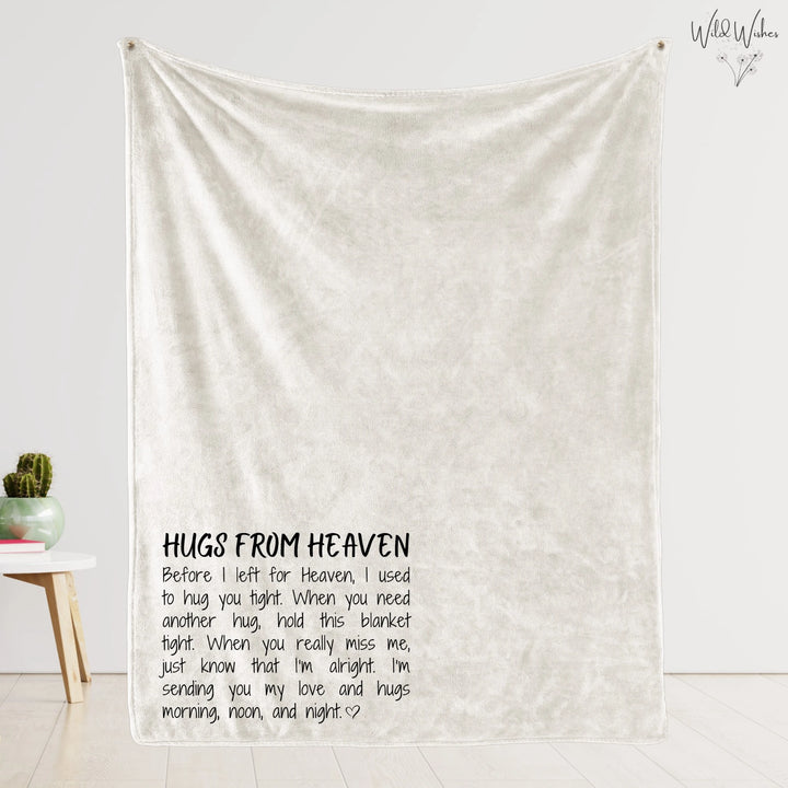 Cream-colored 'Hugs from Heaven' memorial blanket displayed, showing poem in left corner